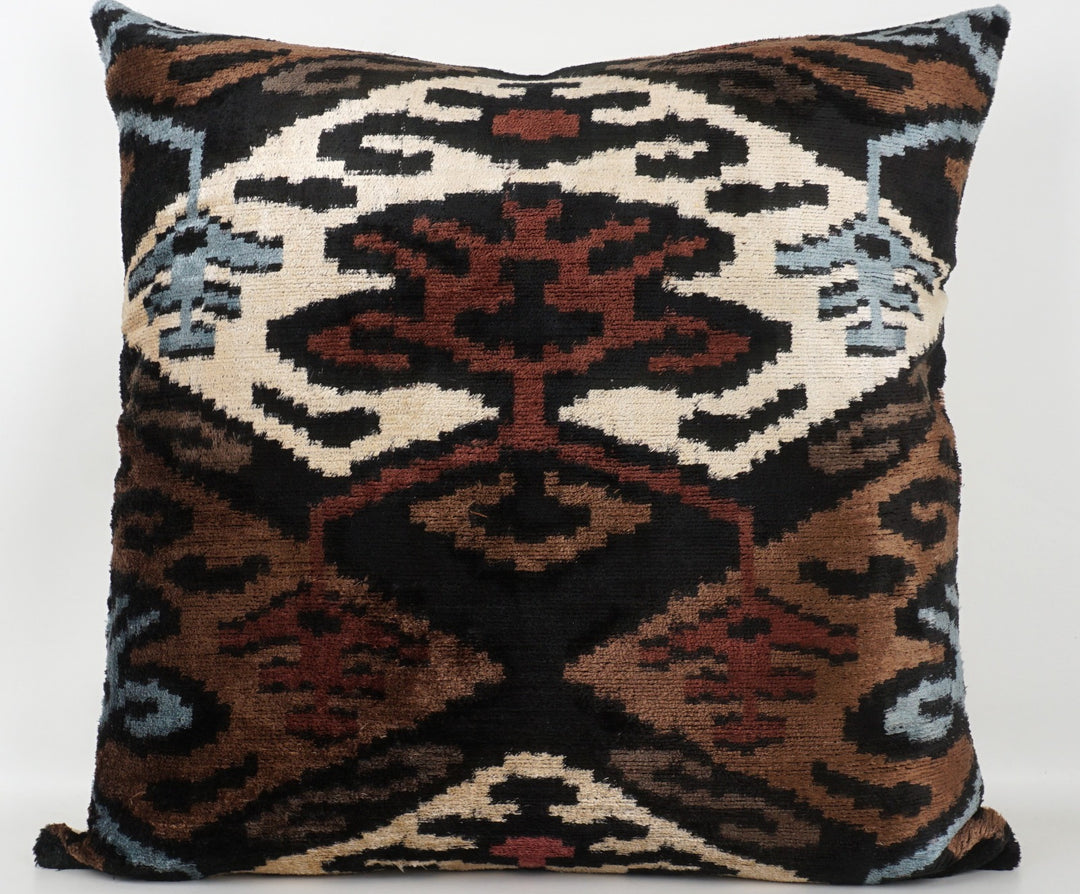 Seidenkissen 50×50 mit Ikat-Muster in Braun, Beere, Blau, Offwhite und Schwarz; Vorderseite 100 % Seide (Silk-Velvet), Rückseite Baumwolle/Leinen.